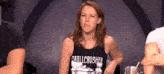 a woman wearing a black tank top that says skullcrusher on it
