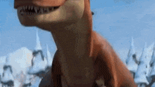 a cartoon dinosaur is standing in the snow in front of a snowy mountain .