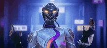 a man in a futuristic suit is holding a cell phone and a knife .