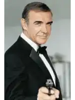 a man in a tuxedo holds a gun in his right hand