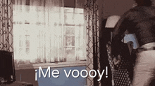 a person is standing in front of a window with the words me voooy on the bottom