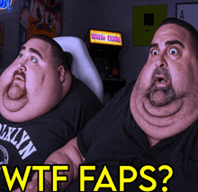 two fat men are sitting in front of an arcade machine that says worm kong
