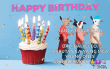 a happy birthday card with a cupcake with candles and three goats