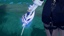 a person is holding a sword with a blue light coming out of the blade