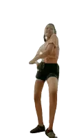 a girl in shorts and a t-shirt is dancing in front of a white background
