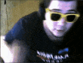 a man wearing sunglasses and headphones is wearing a shirt that says ninja