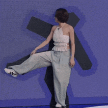 a woman wearing glasses and a white halter top is dancing .