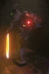 a robot with red eyes and a yellow flame coming out of it 's mouth