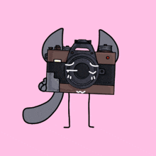 a cartoon drawing of a camera with a cat 's head and legs