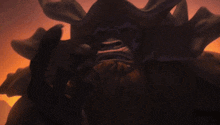 a cartoon character with a beard and horns looks at the camera