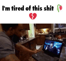 a man watching a movie on a laptop with the words i 'm tired of this shit