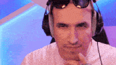 a man wearing headphones and sunglasses is smiling