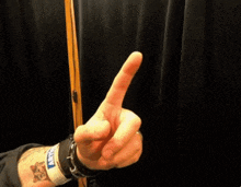 a person with a tattoo on their arm wears a wristband that says nyc