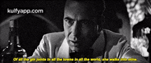 a man in a suit and tie is holding a bottle of alcohol and says of all the gin joints in all the towns