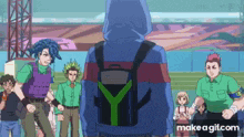 a group of people are standing around a man with a backpack .