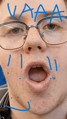 a close up of a man 's face with the word vaaa written on his face