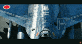 a close up of a blue fighter jet with a red circle on the wing