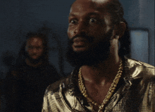 a man with a beard and gold chains says how that one take concern me