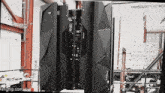 a large black object in a room with a sign that says university of new