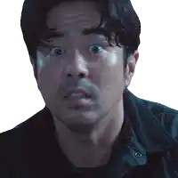 a man with a surprised look on his face is wearing a black jacket