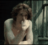 a man without a shirt is sitting in front of a wooden door