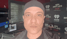 a man wearing a hat that says iheart on it