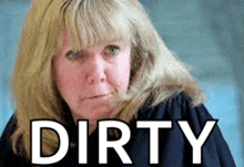 a woman with blonde hair is standing in front of the word dirty