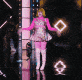 a woman in a pink dress and white boots is holding a diamond shaped object