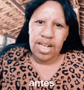a woman wearing a leopard print shirt is talking .