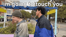 two men are standing next to each other with the words im going to touch you above them
