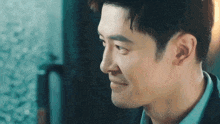 a close up of a man 's face with a slight smile on it .