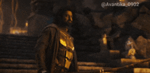 a man with a beard is holding a sword in front of a dark background with the hashtag avantika 0902