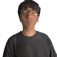 a man wearing glasses and a black shirt that says memphis blowing a kiss