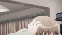 a person 's head is shown in a room with a curtain