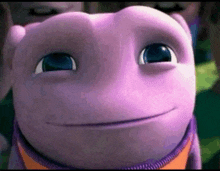 a close up of a purple cartoon character 's face with a smile on it 's face .