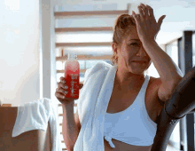 a woman holding a bottle that says sweaty water on it