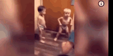 a couple of babies are standing next to each other on a wooden floor .
