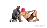 a man in a grey shirt with the word rock on it is kneeling next to a man with pink hair