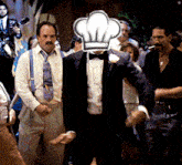 a man in a tuxedo with a chef hat on his head