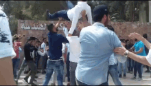 a group of people are dancing in front of a sign that says ' sss ' on it