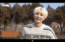a young man in a sweater with going seventeen written on it