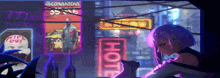 a girl with purple hair is sitting in front of a hotel sign .