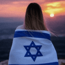 a woman wrapped in a flag with a star of david
