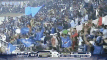 a crowd of people are watching a soccer game with the score 84-2