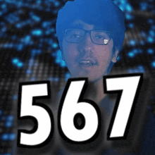 a man wearing glasses stands in front of the number 567