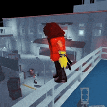a person in a red jacket is standing on a railing