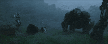 a group of people standing in a field with a giant robot in the background