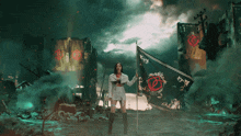 a woman is holding a flag with a circle on it