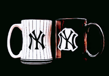 two new york yankees coffee mugs are sitting next to each other