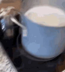 a pot of liquid is cooking on a stove .